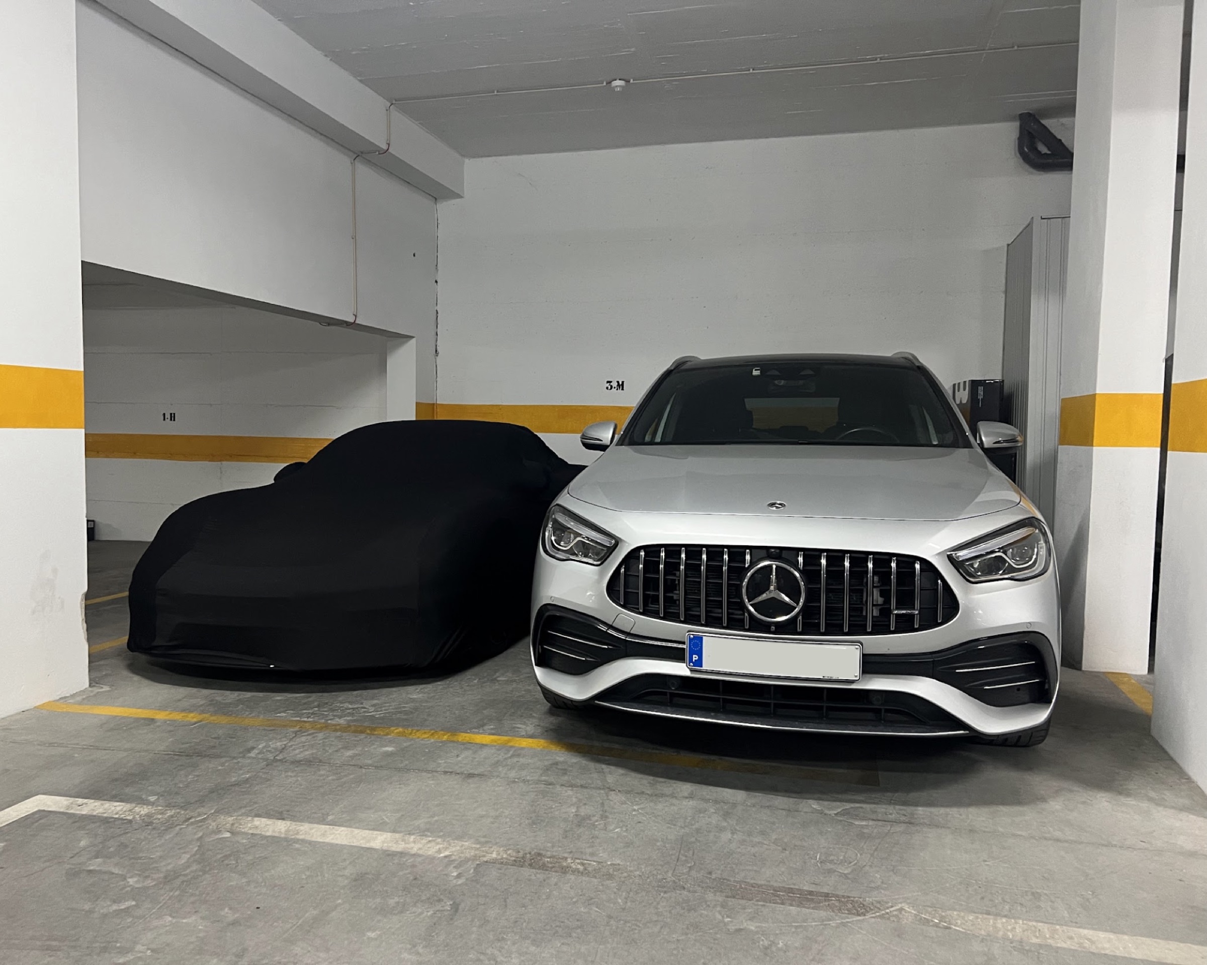 Private underground garage with two cars parked